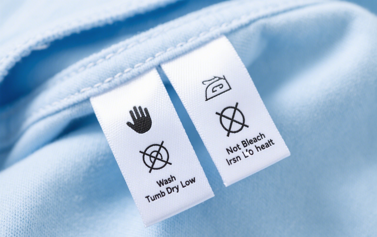 Detailed clothing care tags with washing and care instructions for garment longevity.